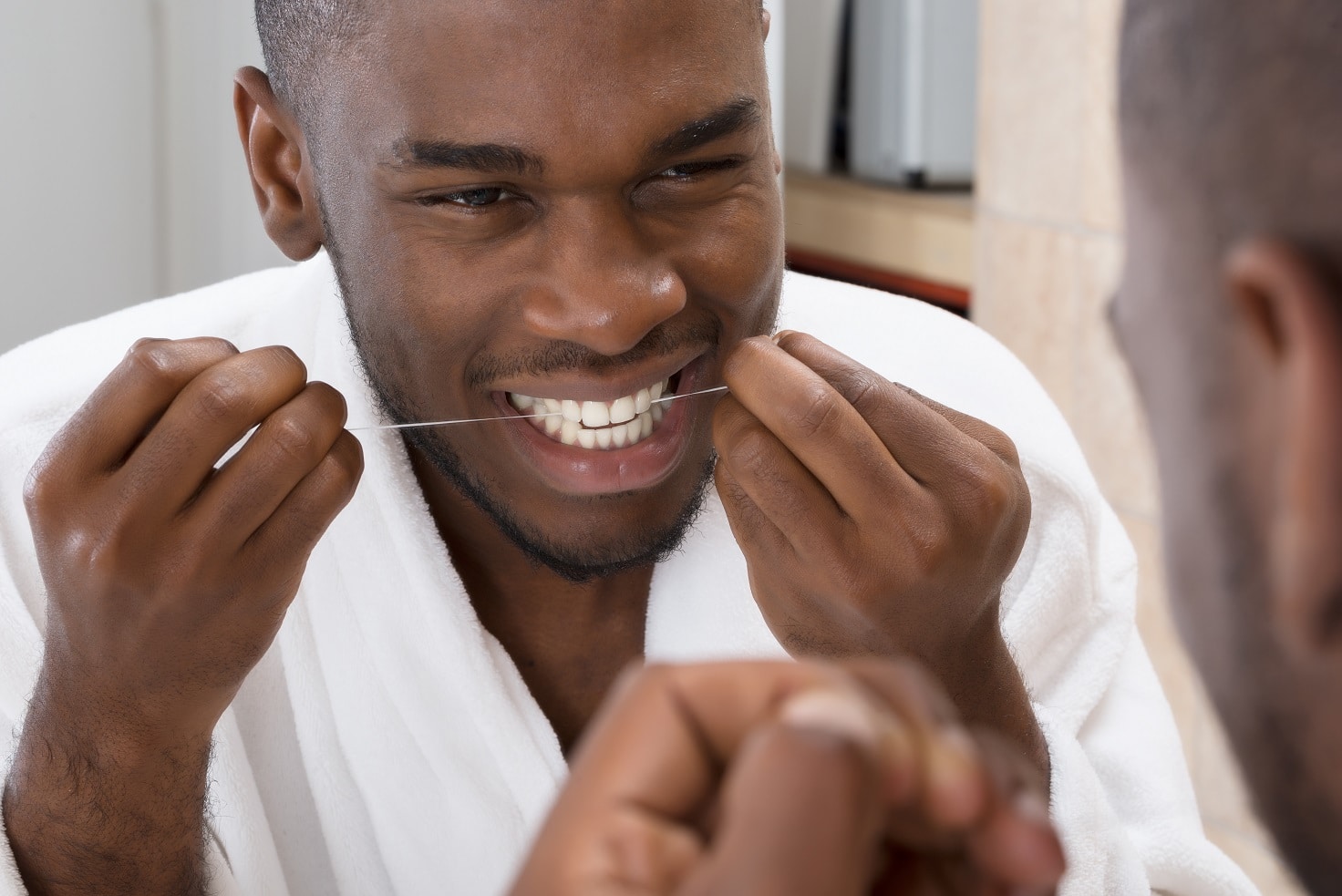 African Man Flossing His Teeth