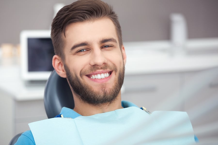 Smiling Man in a Chair Waiting for a Dental Checkup